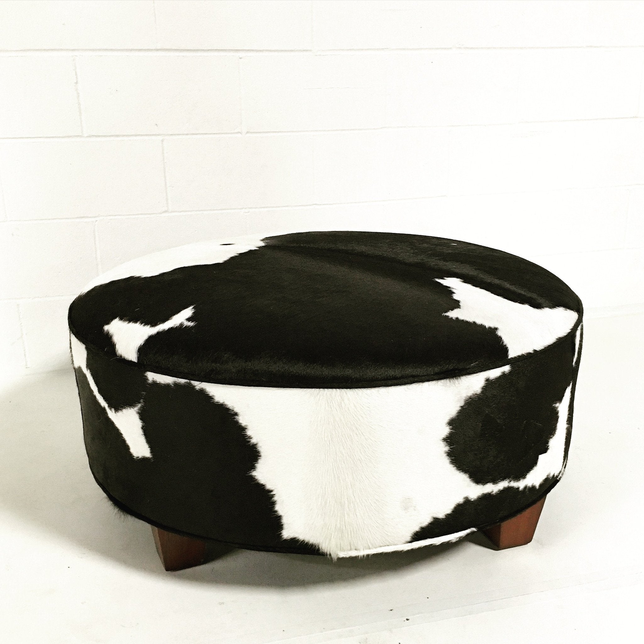 ROUND BLACK & WHITE COWHIDE OTTOMAN