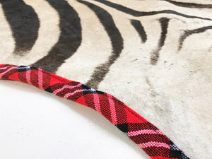 Zebra Hide Rug Trimmed in Maasai Shuka