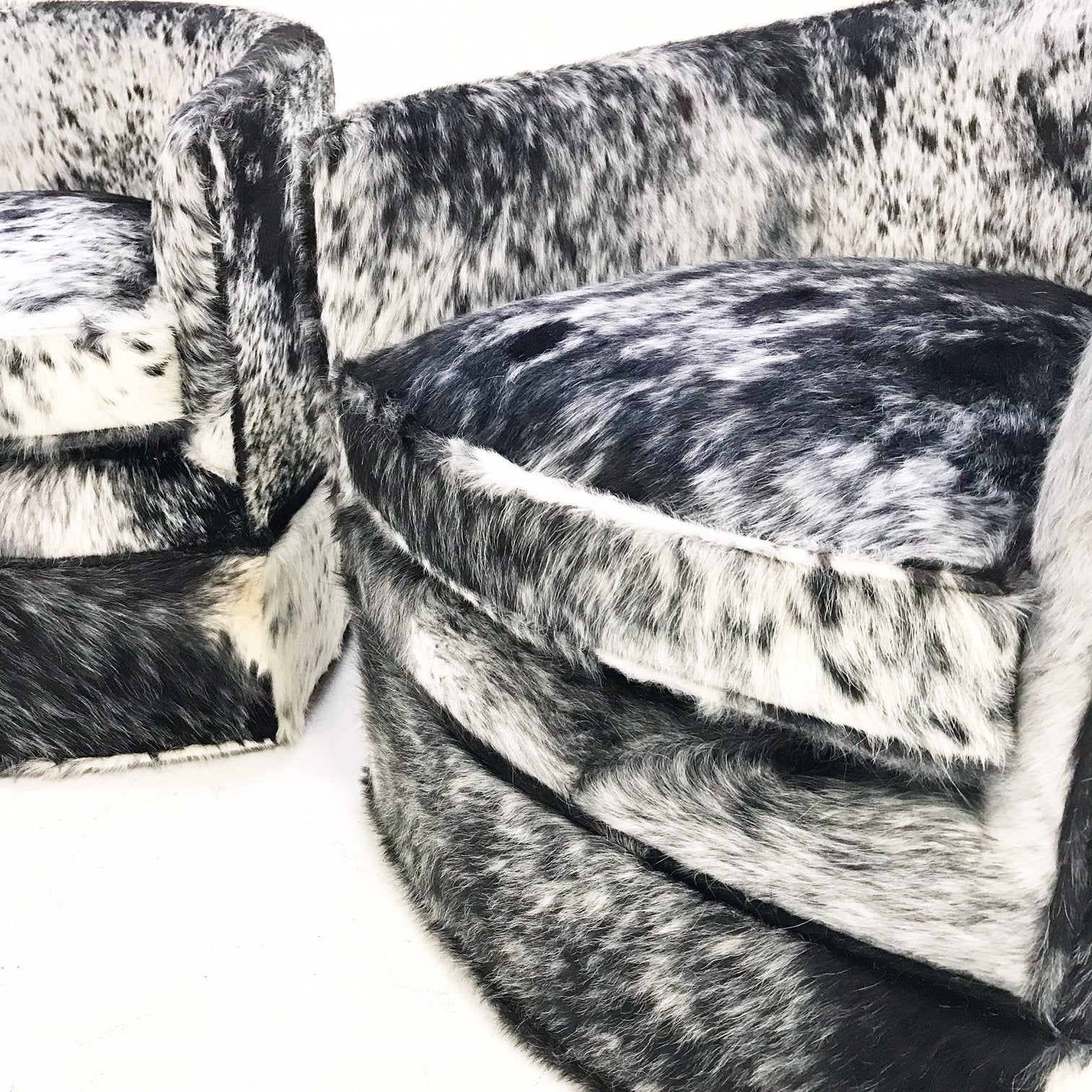 Milo Baughman Wheeled Slipper Chairs Restored and Reupholstered in Black and White Speckled Brazilian Cowhide