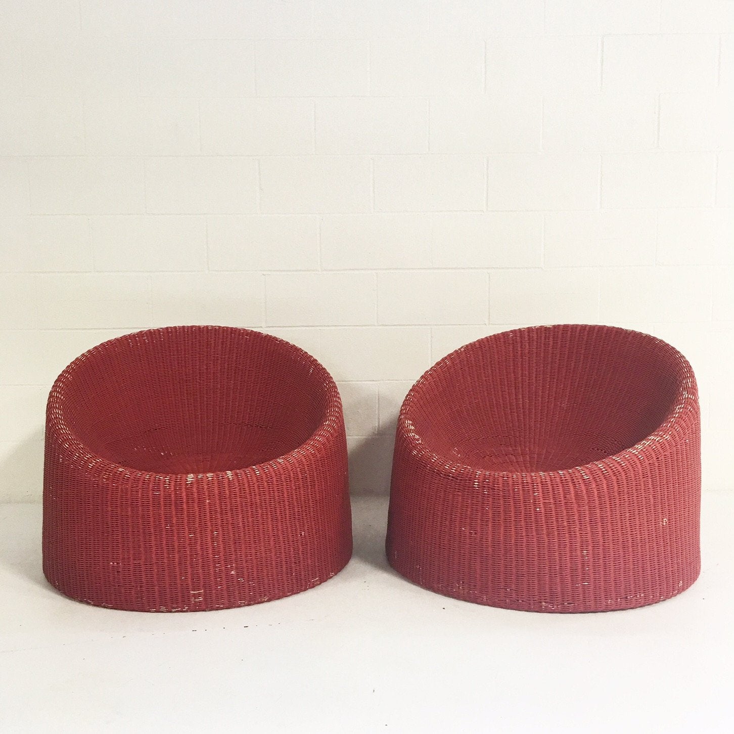 PAIR of EERO AARNIO FOR STENDIG WOVEN RATTAN LOUNGE CHAIRS WITH SHEEPSKIN THROWS