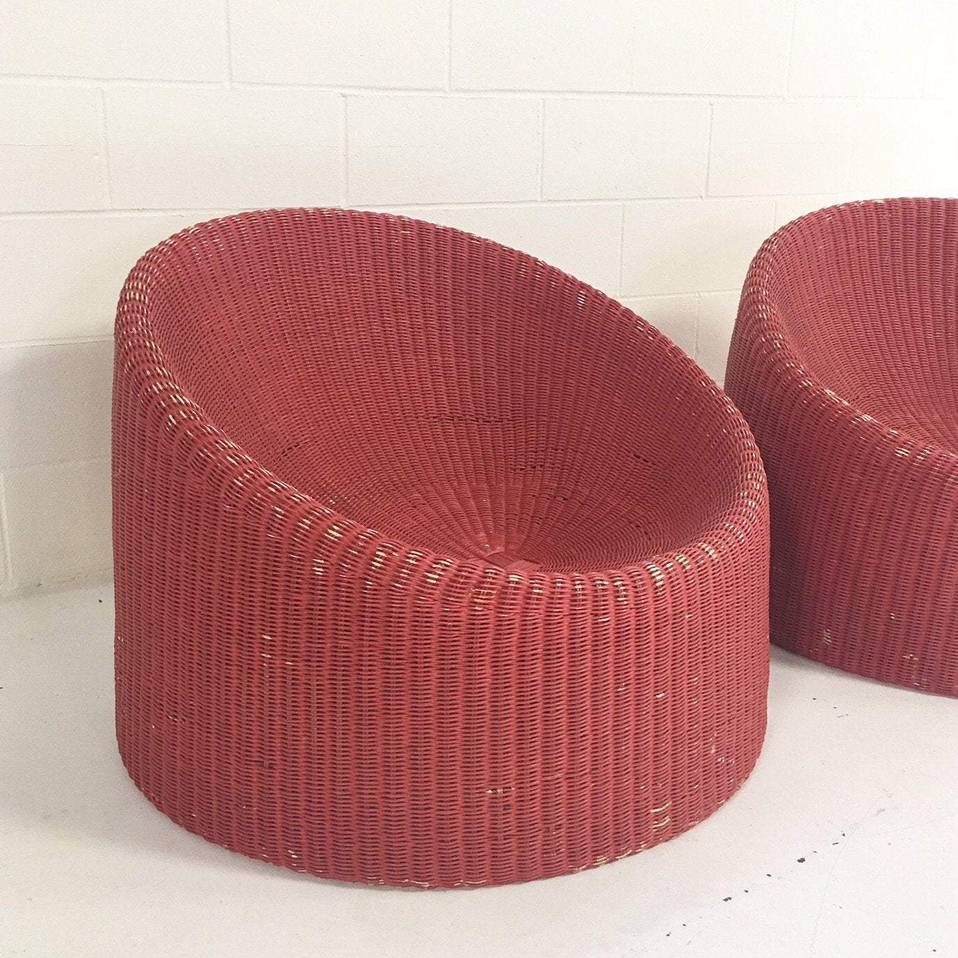 PAIR of EERO AARNIO FOR STENDIG WOVEN RATTAN LOUNGE CHAIRS WITH SHEEPSKIN THROWS