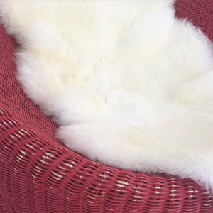 PAIR of EERO AARNIO FOR STENDIG WOVEN RATTAN LOUNGE CHAIRS WITH SHEEPSKIN THROWS