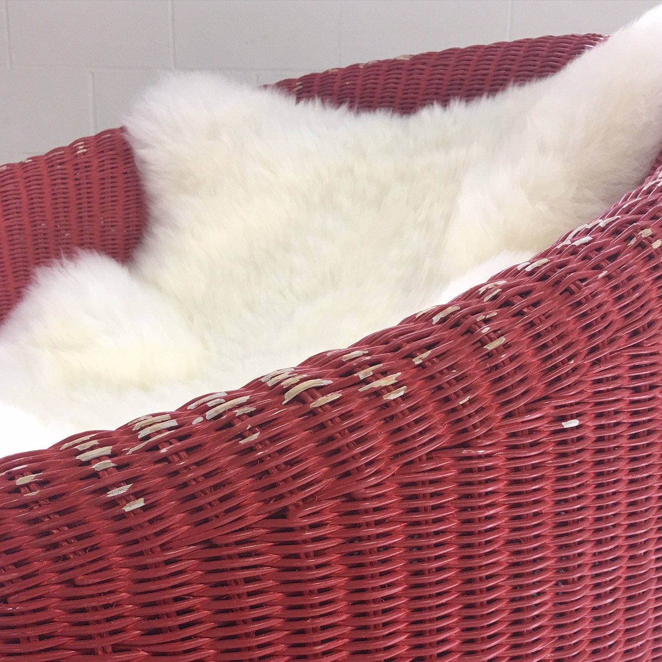 PAIR of EERO AARNIO FOR STENDIG WOVEN RATTAN LOUNGE CHAIRS WITH SHEEPSKIN THROWS