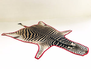Zebra Hide Rug Trimmed in Red Velvet