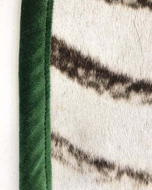 Zebra Hide Rug Trimmed in Schumacher's Emerald Green Silk Velvet