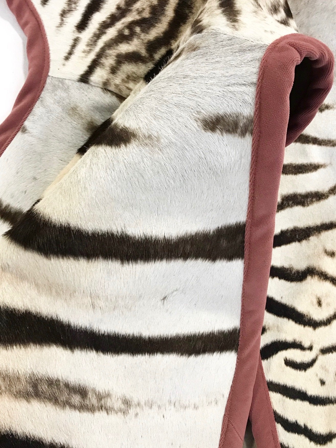 Zebra Hide Rug Trimmed in Blush Pink Velvet