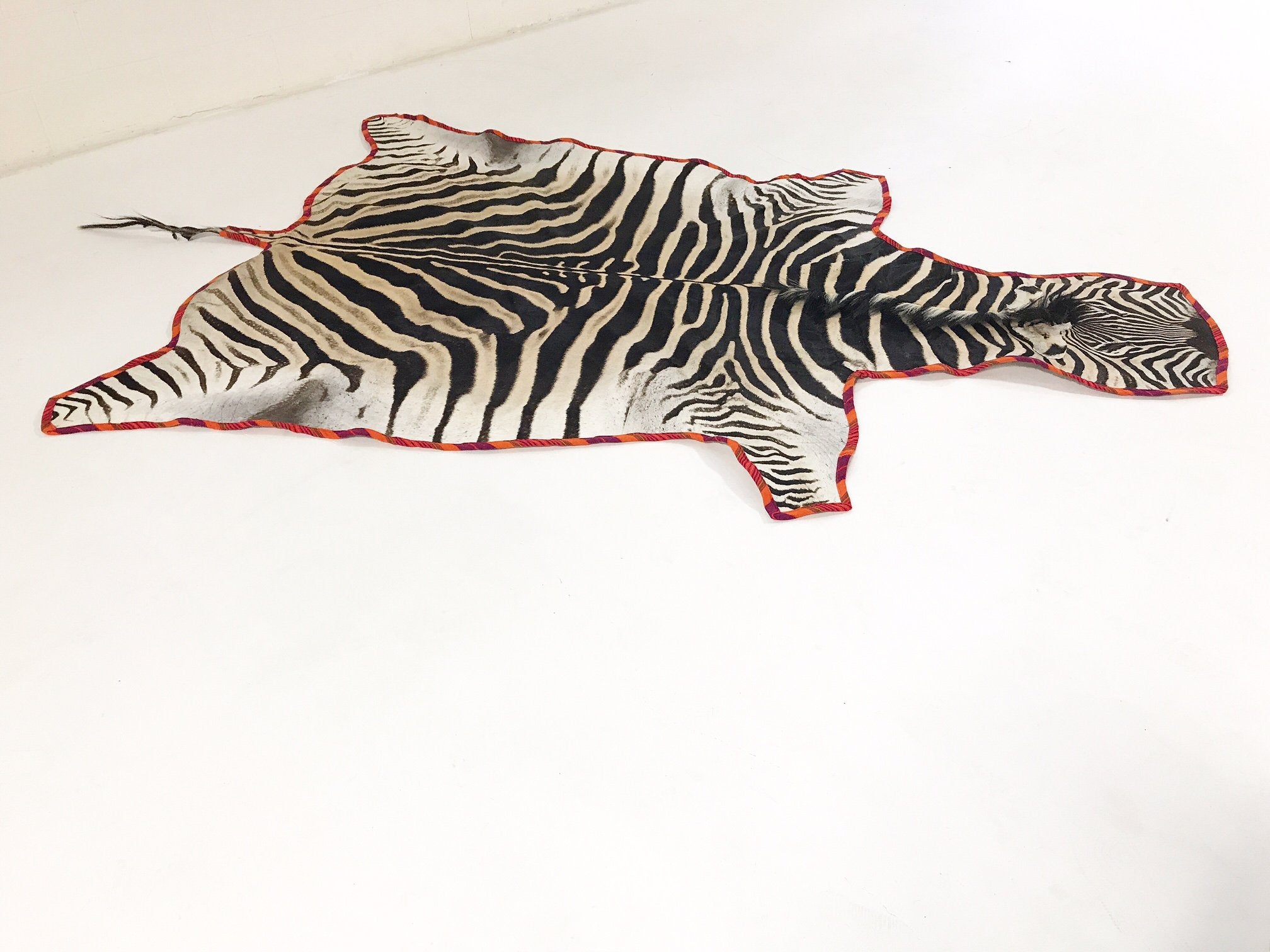 Zebra Hide Rug Trimmed in Maasai Shuka
