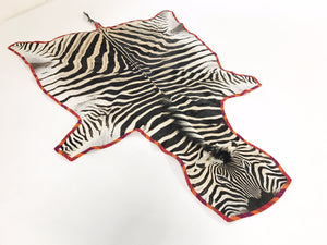 Zebra Hide Rug Trimmed in Maasai Shuka