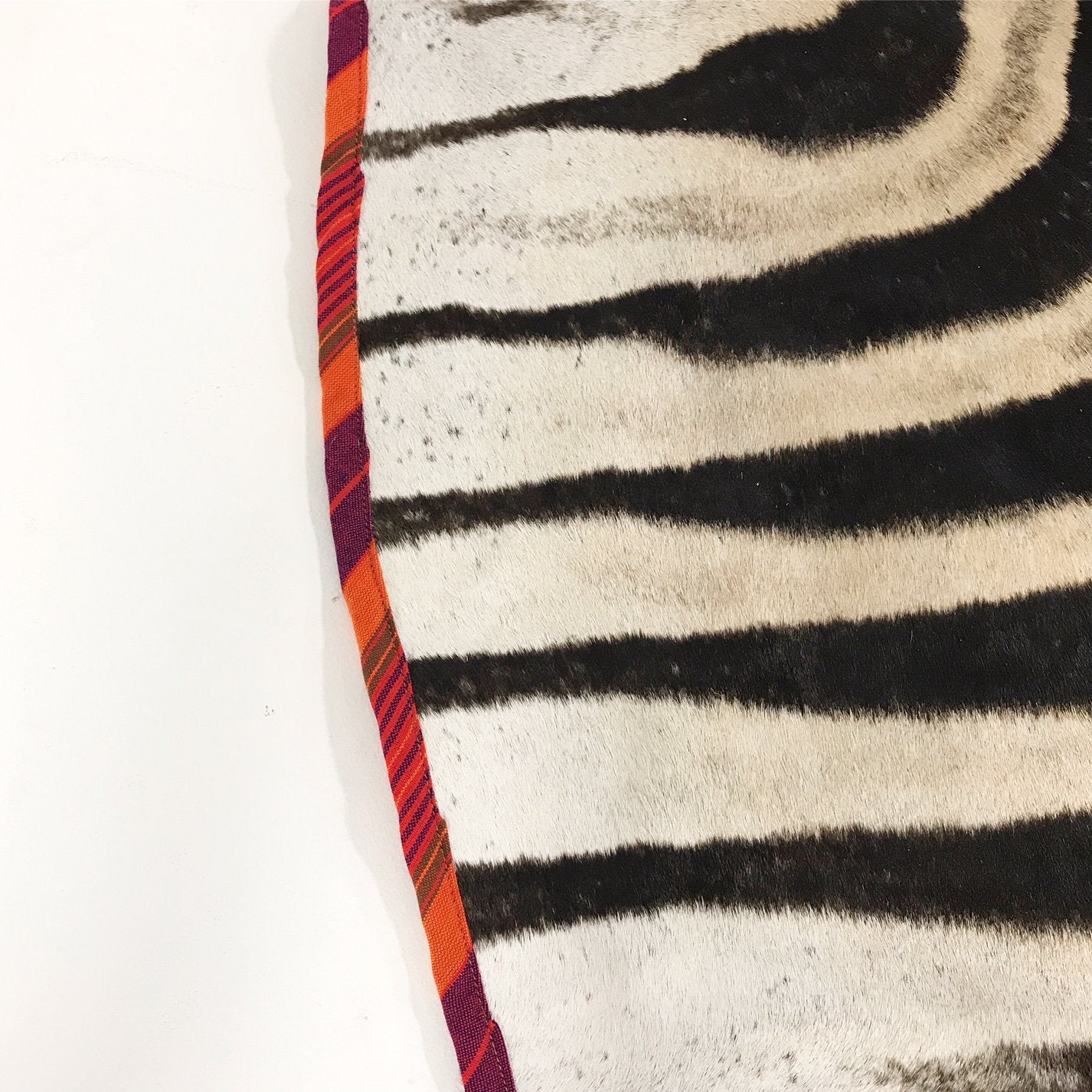Zebra Hide Rug Trimmed in Maasai Shuka