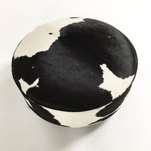 ROUND BLACK & WHITE COWHIDE OTTOMAN