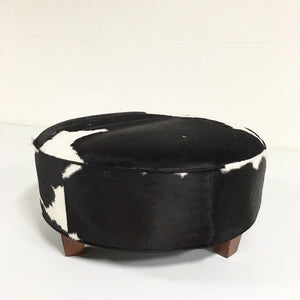 ROUND BLACK & WHITE COWHIDE OTTOMAN