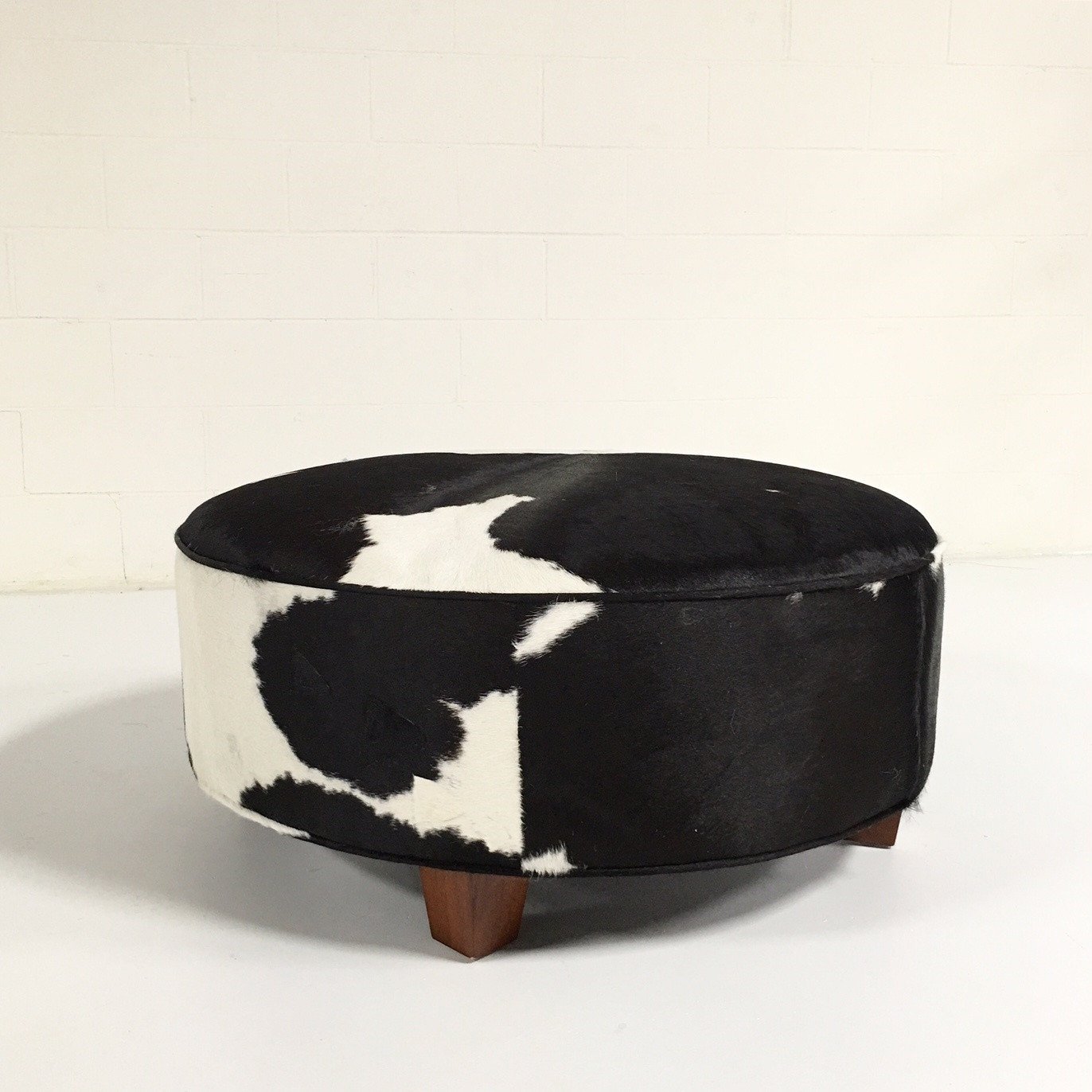 ROUND BLACK & WHITE COWHIDE OTTOMAN