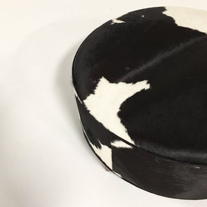 ROUND BLACK & WHITE COWHIDE OTTOMAN